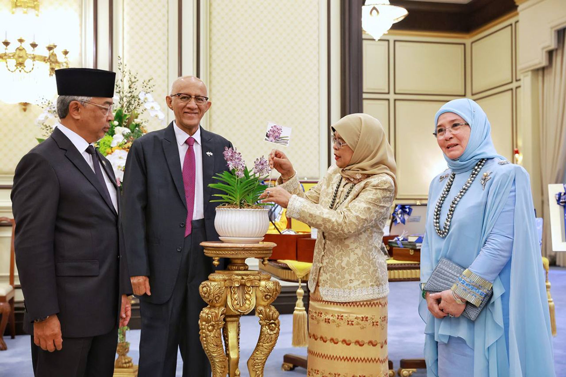 President Halimah and her husband, Mr Mohamed Abdullah Alhabshee, at an orchid naming ceremony with Malaysia’s King, Sultan Abdullah Ahmad Shah, and his wife, Tunku Azizah Aminah Maimunah Iskandariah, at Istana Negara in Kuala Lumpur on March 21, 2023. ST PHOTO: KEVIN LIM