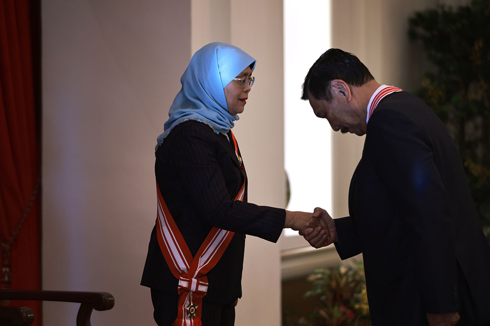 President Halimah conferring the Distinguished Service Order on Mr Luhut Binsar Pandjaitan, Indonesia's Coordinating Minister for Maritime Affairs and Investments, for his significant contributions to bilateral relations between Singapore and Indonesia, on June 5, 2023. ST PHOTO: JASON QUAH