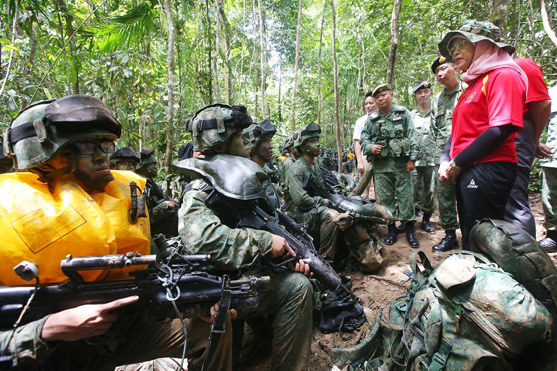 President Halimah, accompanied by then Chief of Army Goh Si Hou (on her right), speaking to Singapore Armed Forces officer cadets during their training in Temburong in Brunei on May 13, 2018. Madam Halimah was in Brunei on her first state visit since she became president. ST PHOTO: GAVIN FOO